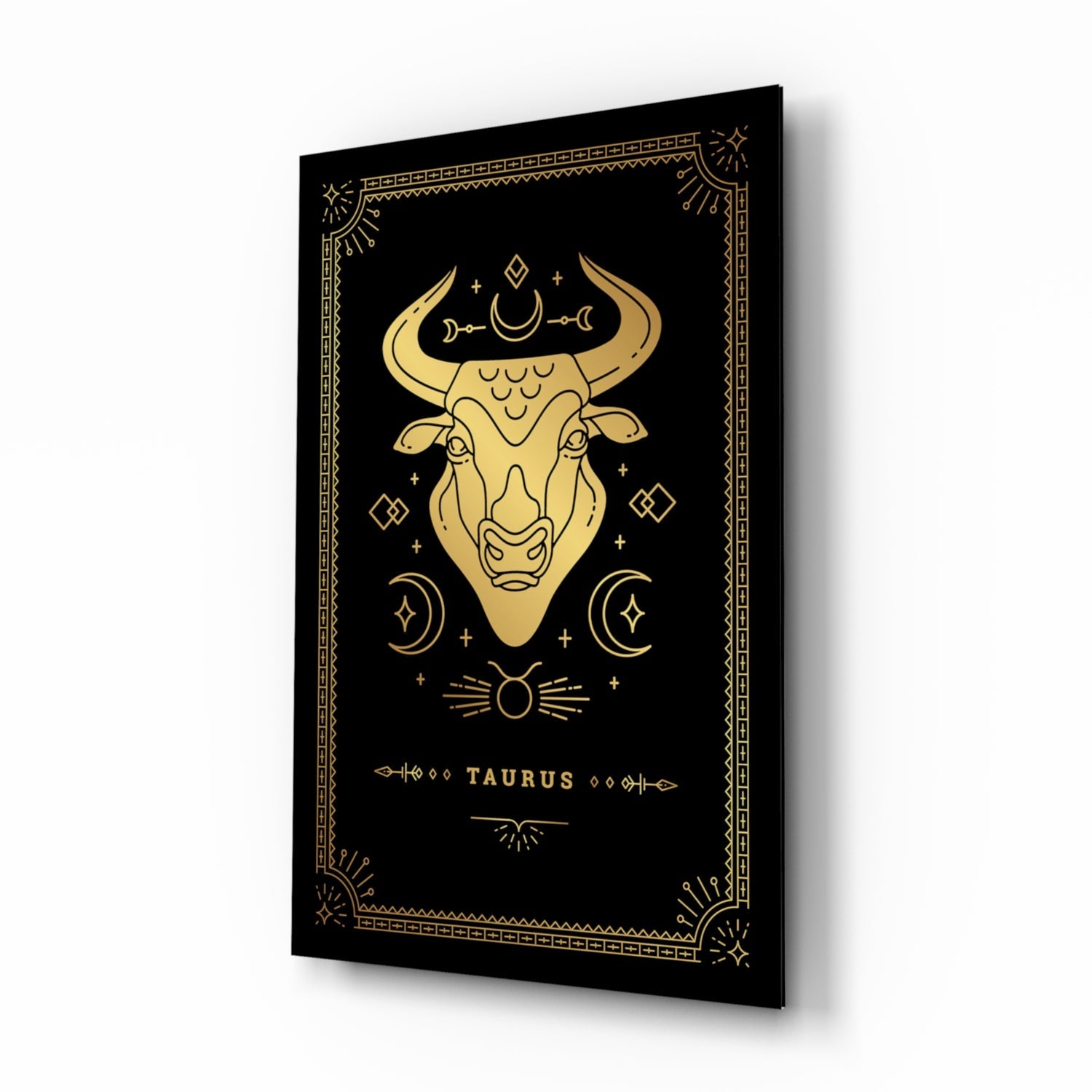 Black glass panel with gold Taurus bull illustration, celestial symbols, and decorative border displayed at an angle.