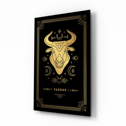 Black glass panel with gold Taurus bull illustration, celestial symbols, and decorative border displayed at an angle.