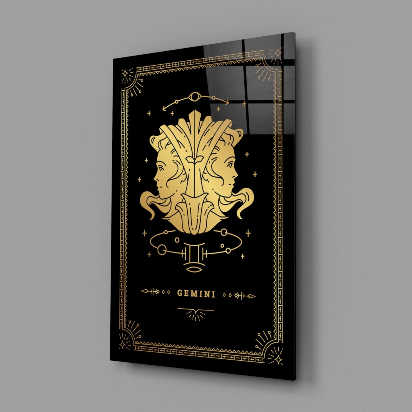 Angled perspective view of black glass wall art featuring gold Gemini twins design with decorative border and astrological symbols.
