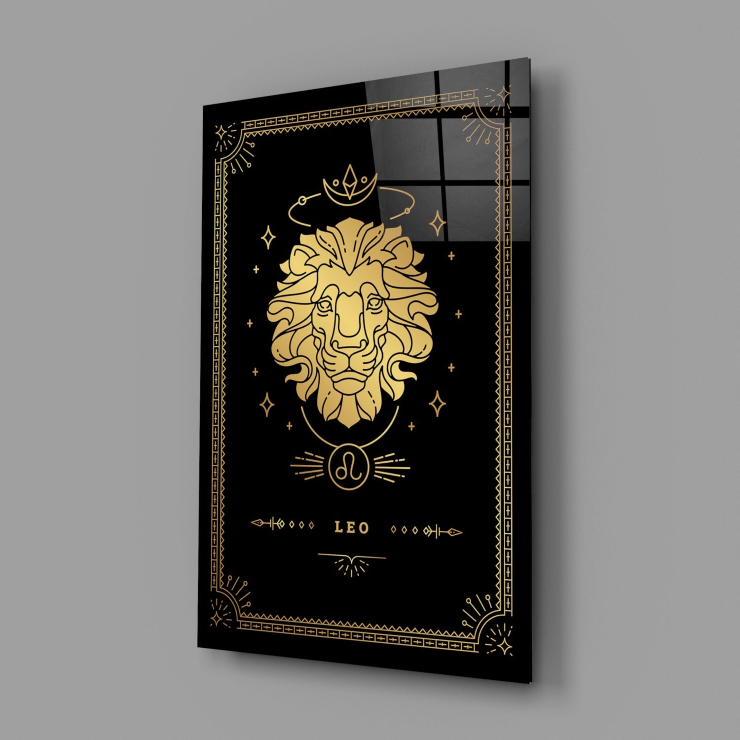 Angled view of black glass wall art with gold Leo zodiac lion design, decorative border, and celestial symbols on dark background.