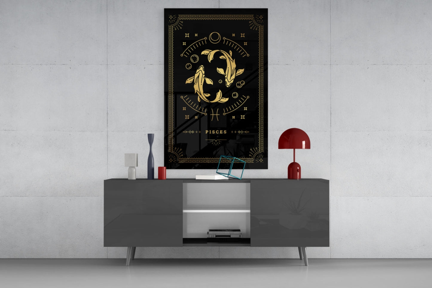 Black glass Pisces zodiac wall art with gold fish design displayed above gray media console with red lamp and decorative accessories.