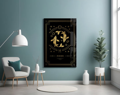 Black glass wall art displaying gold Pisces zodiac symbol with decorative borders and text, hung in modern room with teal walls and white furniture.