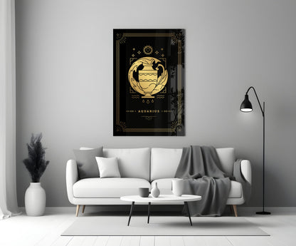 Black glass wall art with gold Aquarius zodiac symbol and decorative border displayed above white sofa in modern living room.