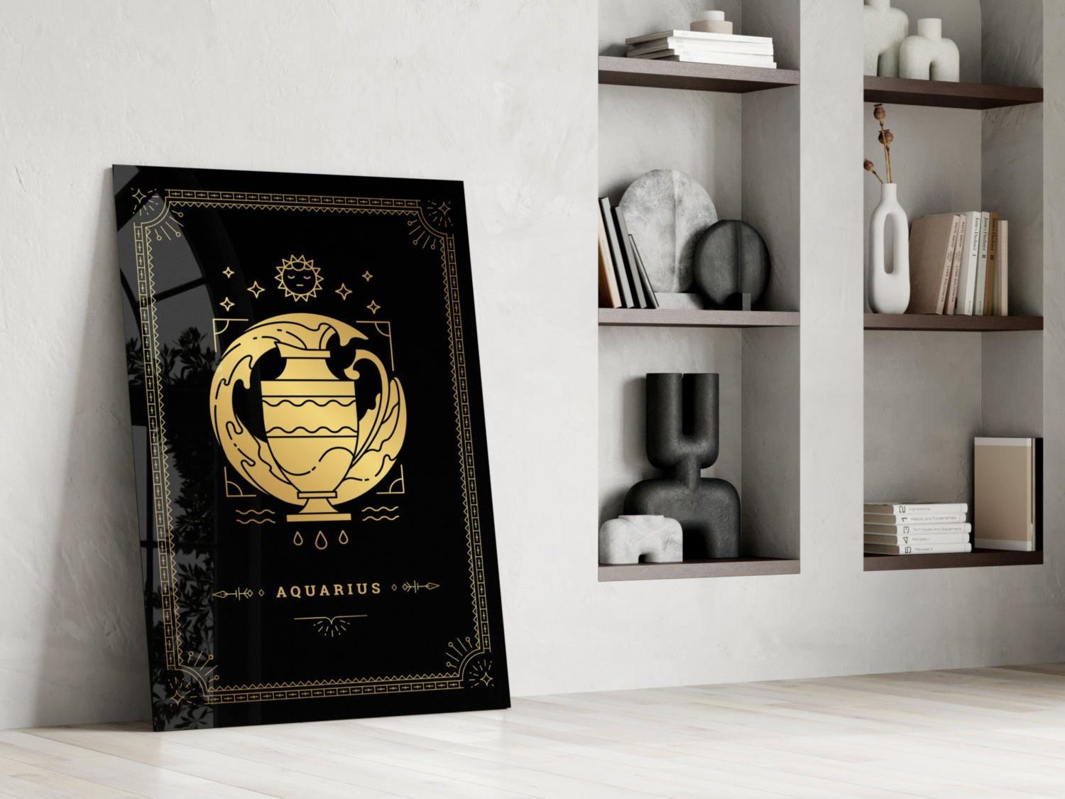 Black and gold Aquarius zodiac glass wall art leaning against white wall beside shelving unit with decorative objects.