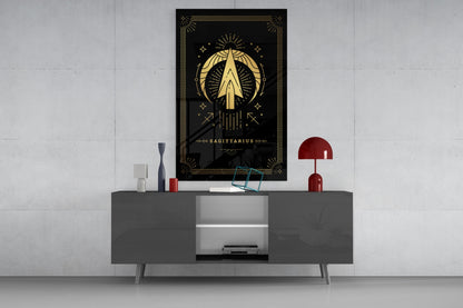 Black glass Sagittarius zodiac wall art with gold celestial design displayed above gray media console in modern interior setting.