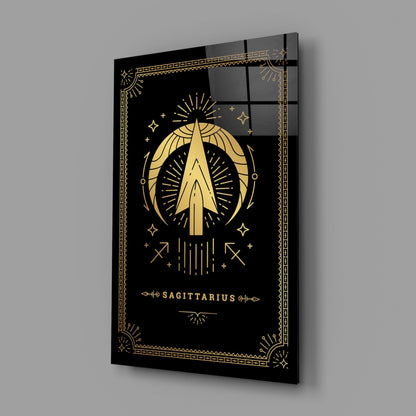 Angled perspective of black glass wall art featuring gold Sagittarius zodiac symbol with decorative border and text on dark background.
