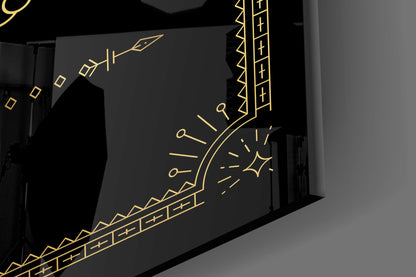 Black glass wall art with gold-outlined Libra zodiac scales design displayed at an angled perspective in interior setting.