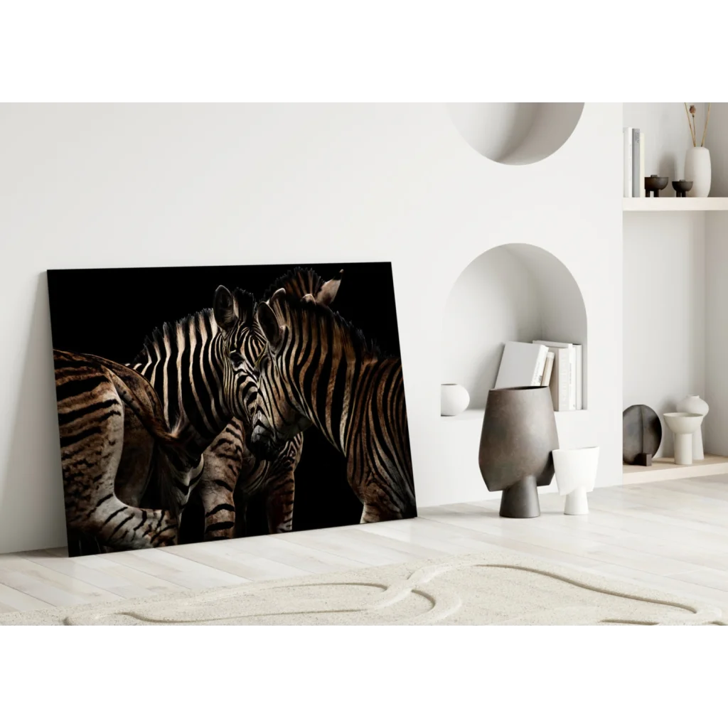Stunning black-and-white zebras in intimate pose on glass wall art