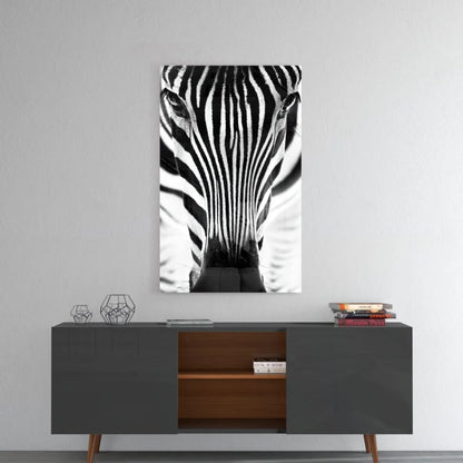 Black-and-white zebra glass wall art portrait above dark gray console