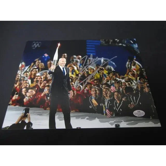 Zinedine Zidane Signed Torch 8x10 Photo Olympic Collectible featuring man with torch