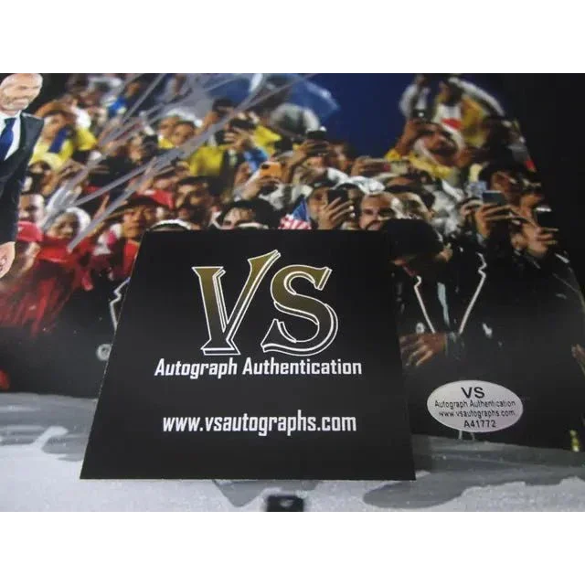 Black card with gold and white VS logo and website, part of Zinedine Zidane Signed Torch 8x10 collectible