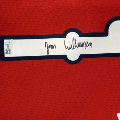 Red fabric with black-bordered white nameplate signed Zion Williamson for Pelicans jersey display